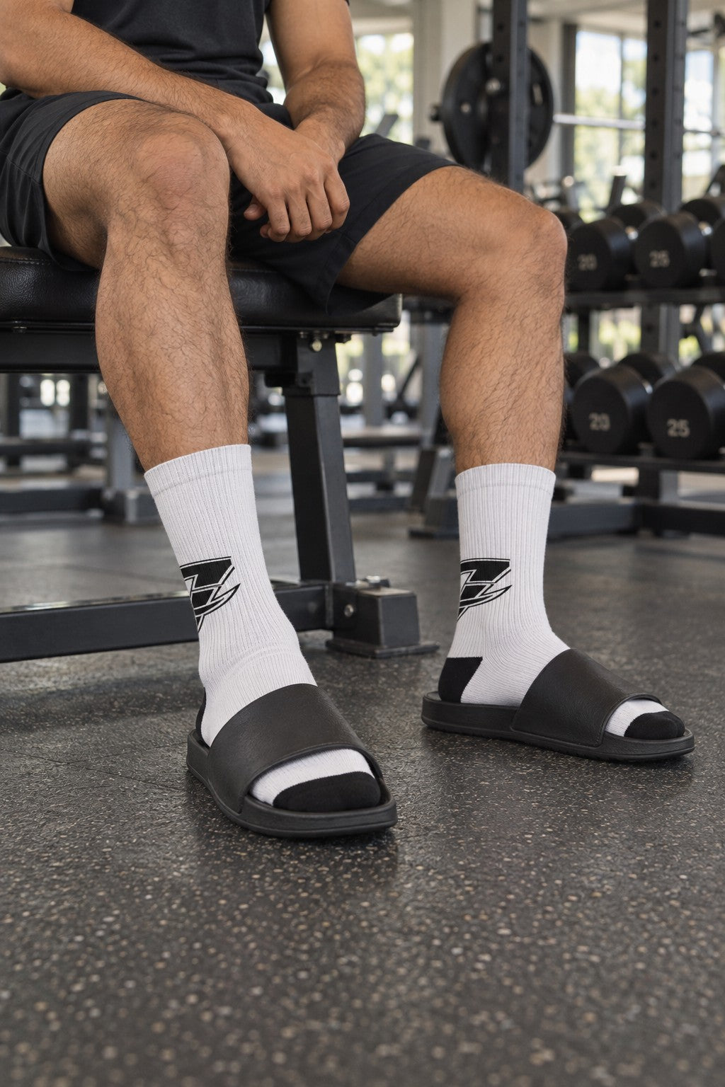 Custom Sublimation Crew Socks with Black Logo – front view on a male athlete