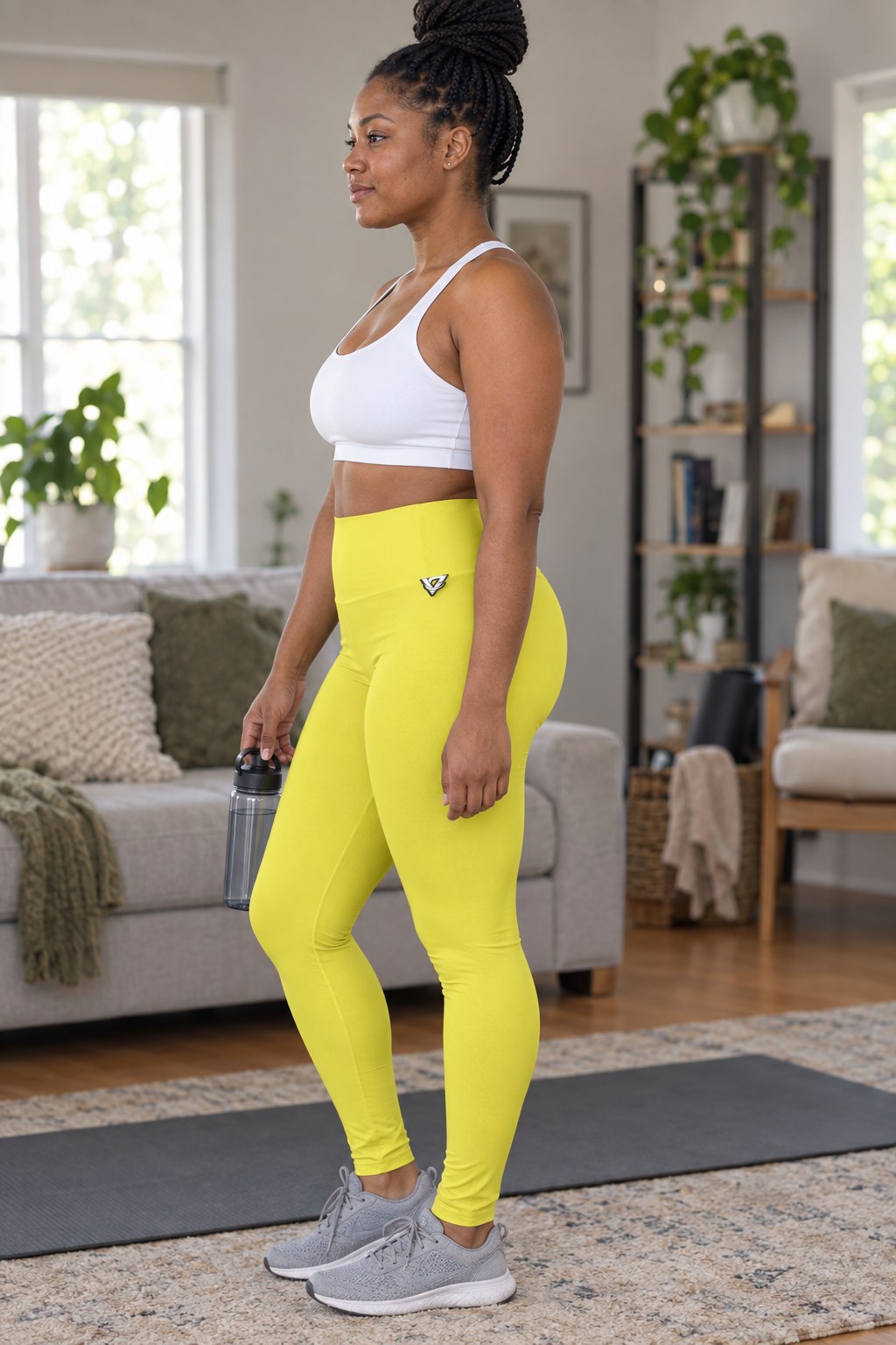 Woman wearing the Lemon Yellow Essential High-Waisted Yoga Leggings with the Vantacore V emblem on the hip – side view showing the V emblem on the hip