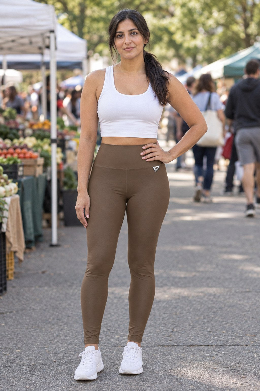 Woman wearing the Mocha Brown Essential High-Waisted Yoga Leggings with the Vantacore V emblem on the hip – front view