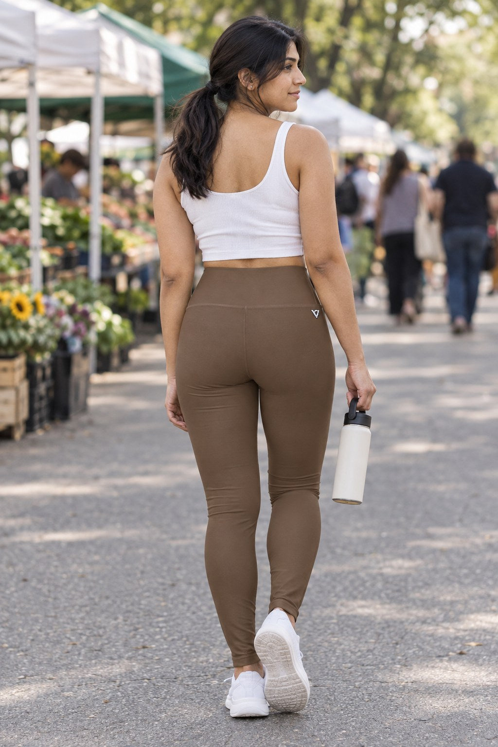Woman wearing the Mocha Brown Essential High-Waisted Yoga Leggings with the Vantacore V emblem on the hip – back view