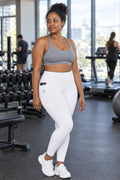Arctic White Essential leggings with pockets, AI-generated fictional adult model – front three-quarter view showing the side pocket