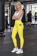 Lemon Yellow Essential leggings with pockets, AI-generated fictional adult model – front three-quarter view showing the side pocket