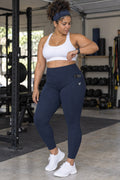 Midnight Navy Essential leggings with pockets, AI-generated fictional adult model – front three-quarter view showing the side pocket