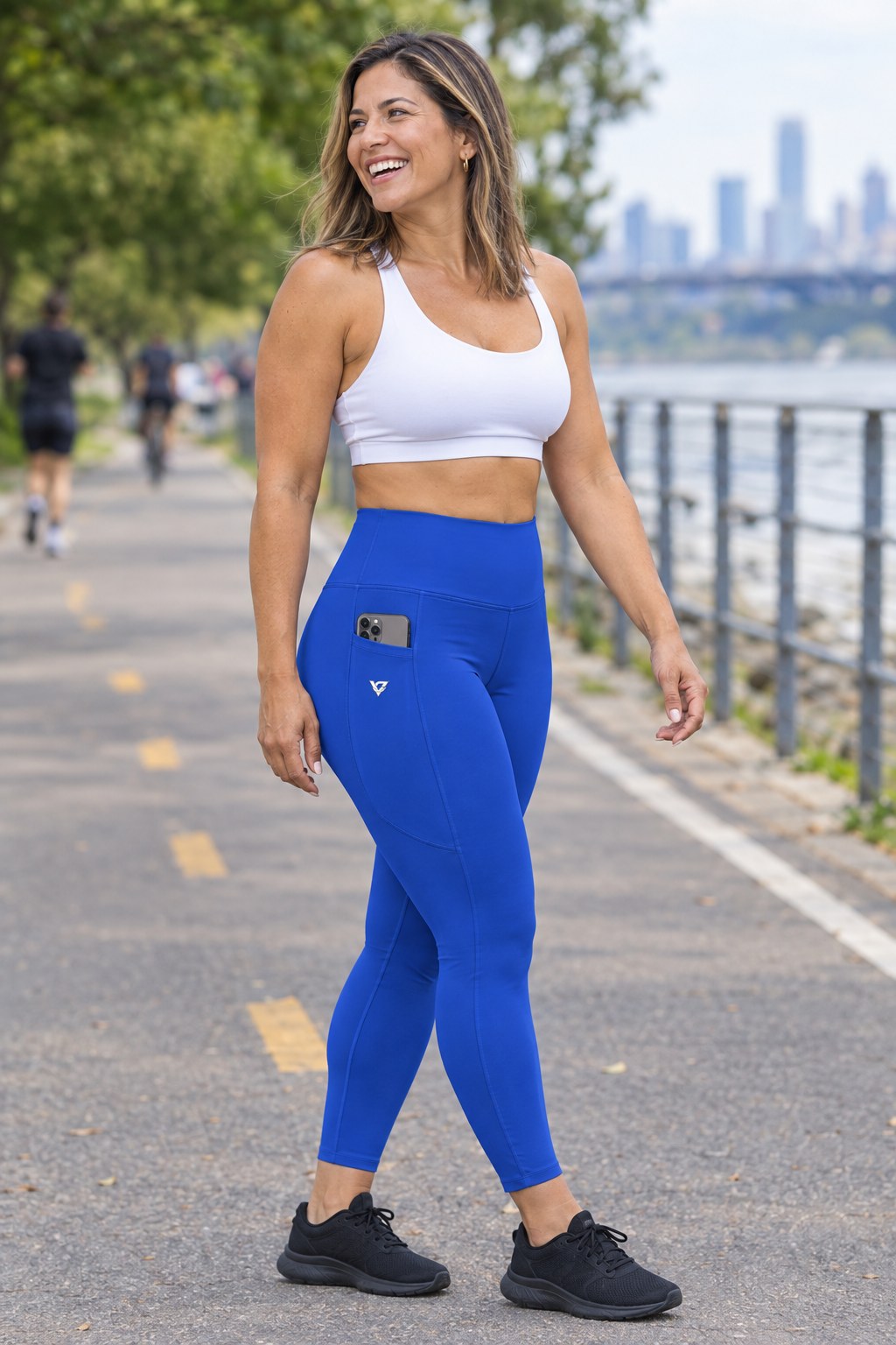 Royal Blue Essential leggings with pockets, AI-generated fictional adult model – front three-quarter view showing the side pocket