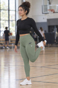 Sage Green Essential leggings with pockets, AI-generated fictional adult model – front three-quarter view showing the side pocket