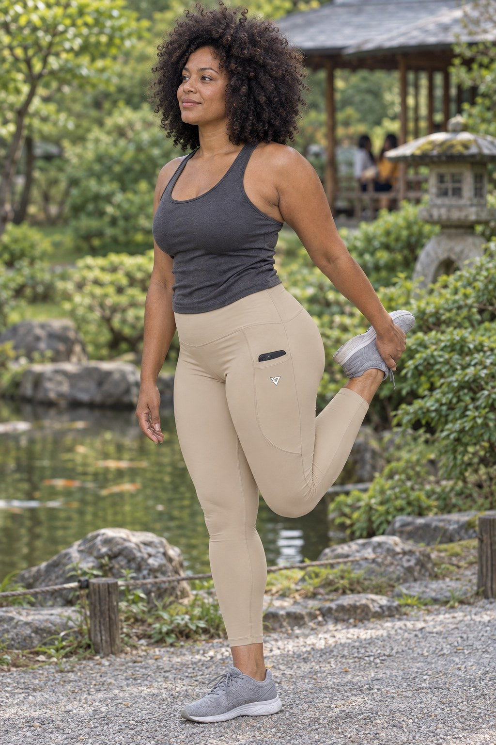 Sand Beige Essential leggings with pockets, AI-generated fictional adult model – front three-quarter view showing the side pocket