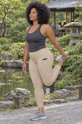 Sand Beige Essential leggings with pockets, AI-generated fictional adult model – front three-quarter view showing the side pocket