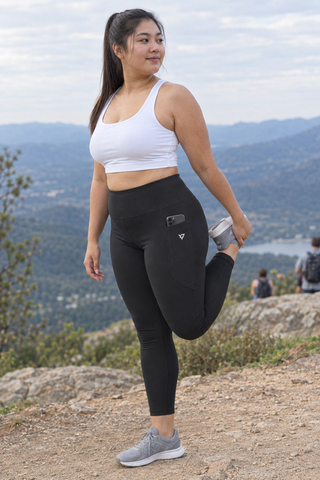 Stealth Black Essential leggings with pockets, AI-generated fictional adult model – front three-quarter view showing the side pocket