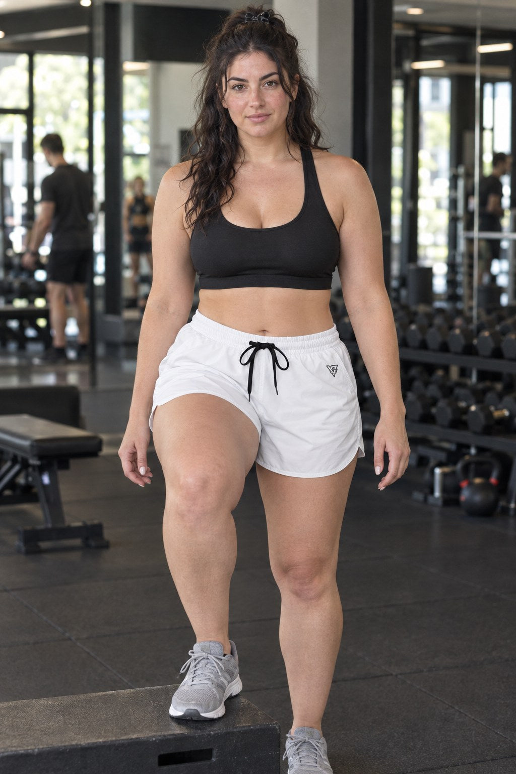 Woman wearing the Arctic White Essential women's athletic shorts with pockets and the Vantacore V emblem – front view