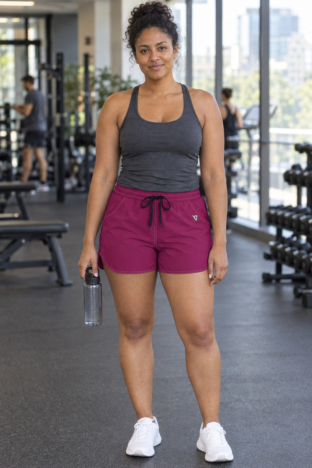 Woman wearing the Berry Essential women's athletic shorts with pockets and the Vantacore V emblem – front view