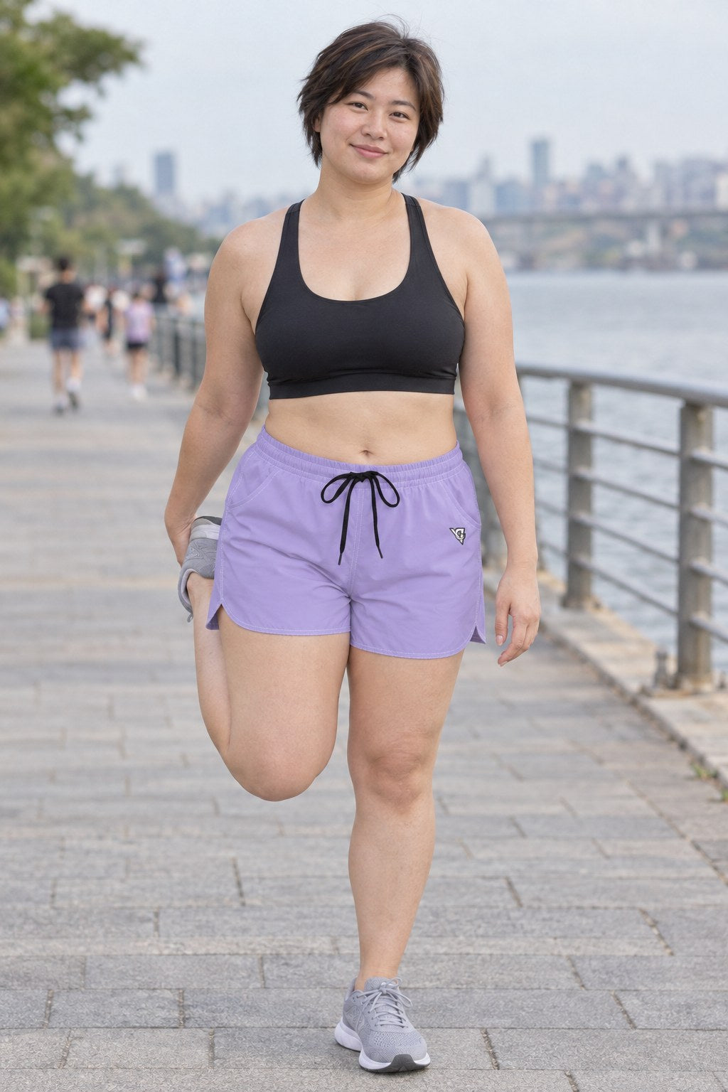 Woman wearing the Lavender Essential women's athletic shorts with pockets and the Vantacore V emblem – front view