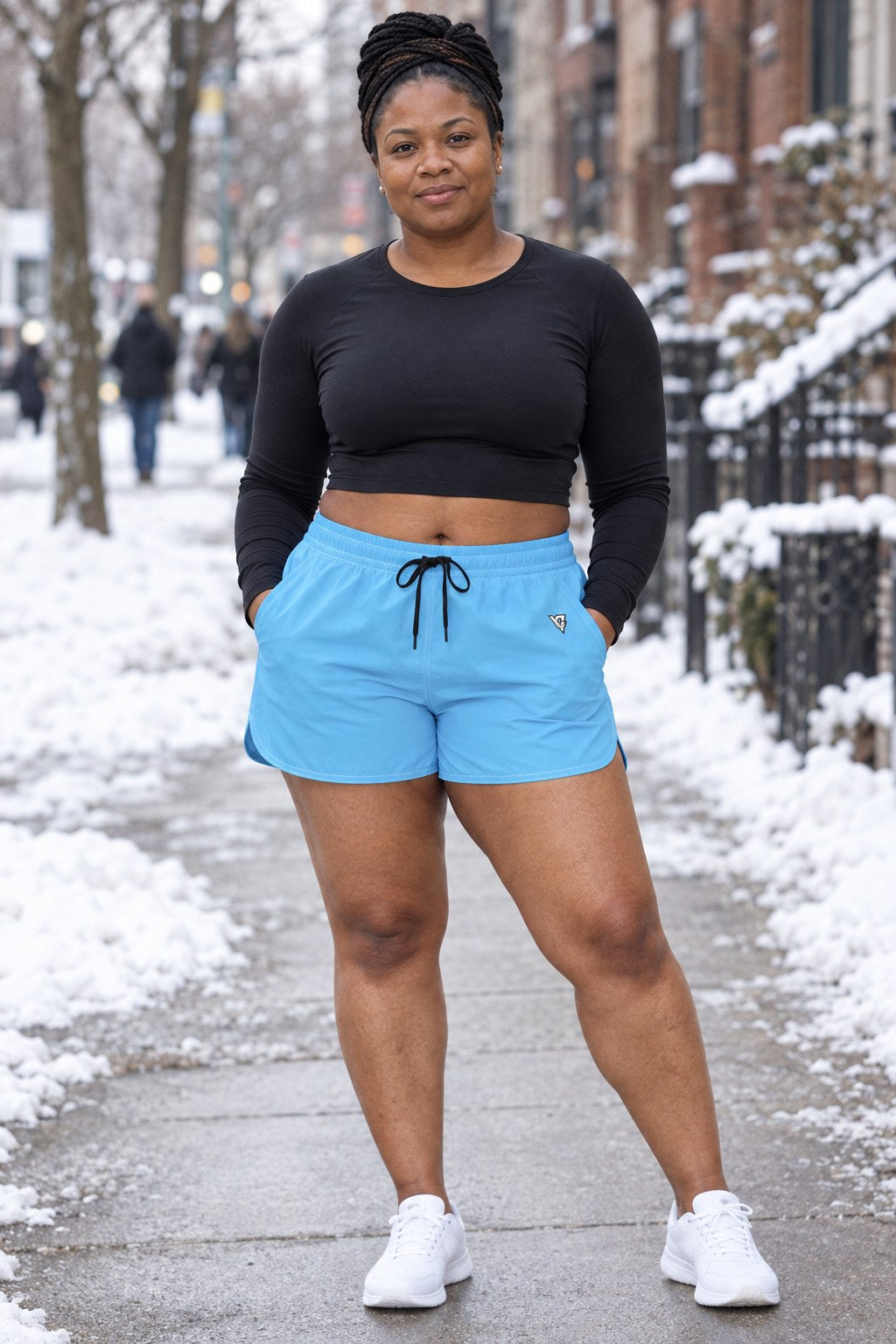Woman wearing the Sky Blue Essential women's athletic shorts with pockets and the Vantacore V emblem – front view