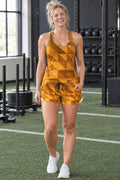 Woman wearing the Amber Low-Poly women's full-length racerback tank and pocket shorts matching set by Vantacore Athletics