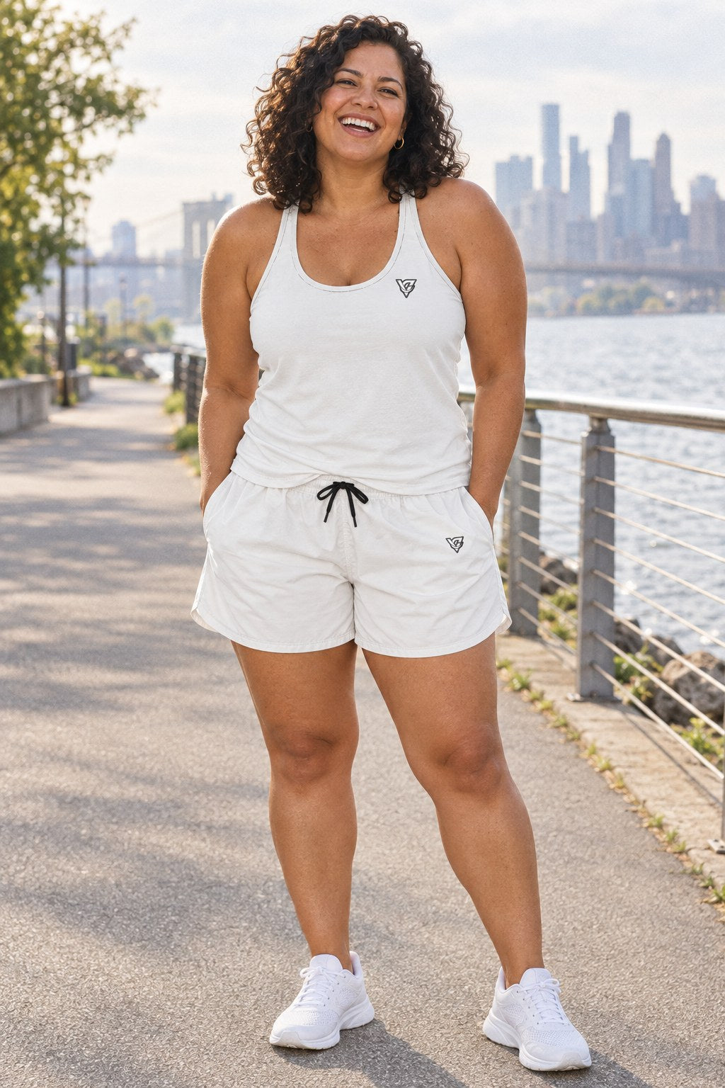 Woman wearing the Arctic White Essential women's full-length racerback tank and pocket shorts matching set by Vantacore Athletics