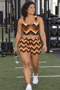Woman wearing the Copper Chevron women's matching crop tank by Vantacore Athletics, shown with the matching pocket shorts (sold separately)