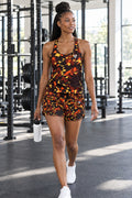 Woman wearing the Ember Splatter women's full-length racerback tank and pocket shorts matching set by Vantacore Athletics