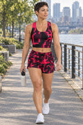 Woman wearing the Infrared Digital Camo women's matching crop tank by Vantacore Athletics, shown with the matching pocket shorts (sold separately)