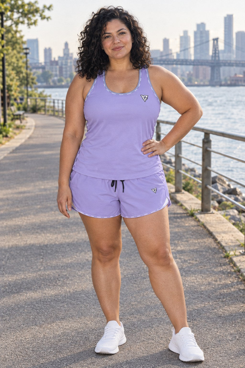 Woman wearing the Lavender Essential women's full-length racerback tank and pocket shorts matching set by Vantacore Athletics