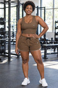 Woman wearing the Mocha Brown Essential women's crop tank and pocket shorts matching set by Vantacore Athletics