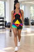 Woman wearing the Neon Gradient women's matching full-length racerback tank by Vantacore Athletics, shown with the matching pocket shorts (sold separately)
