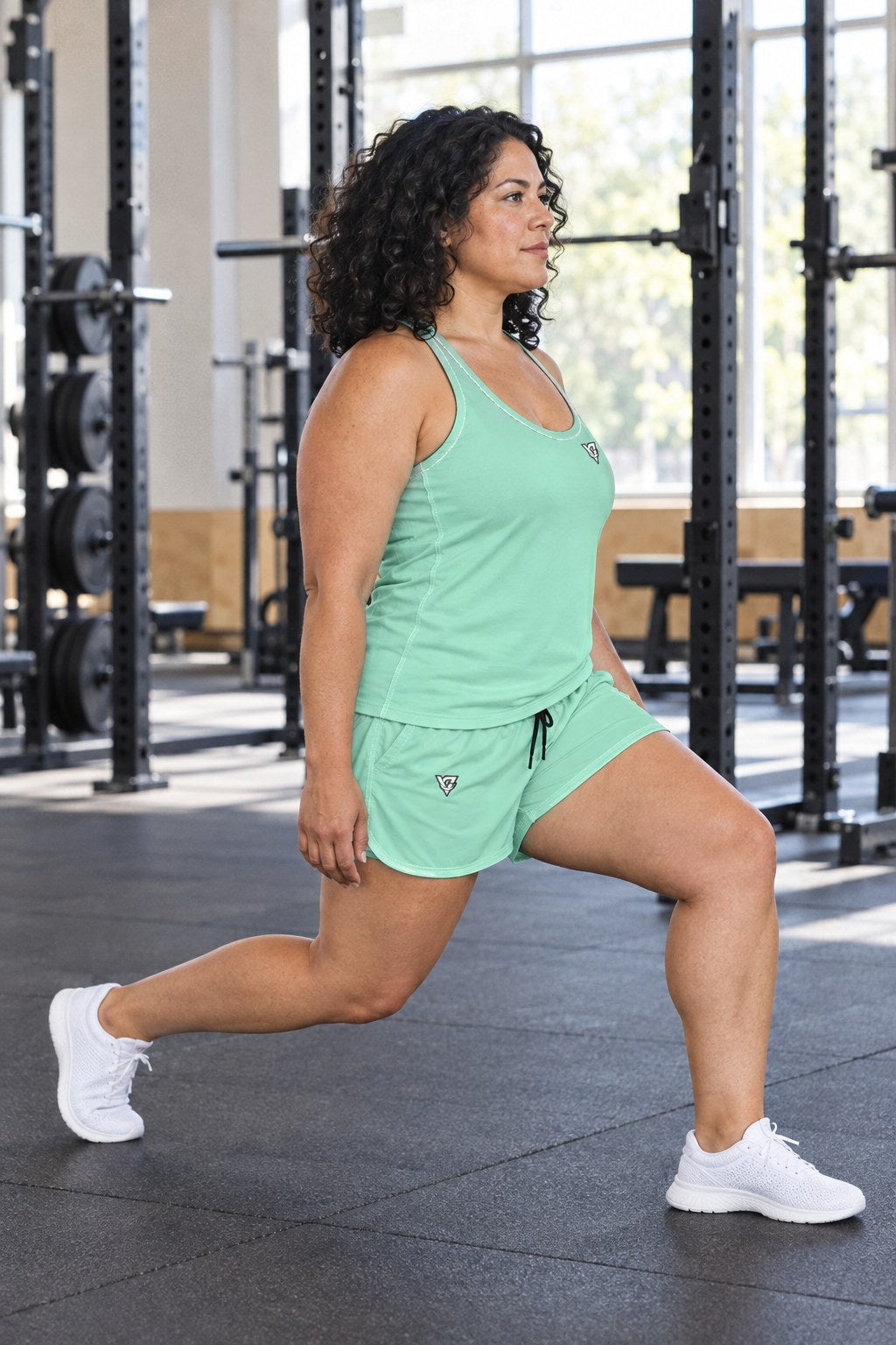 Woman wearing the Seafoam Mint Essential women's full-length racerback tank and pocket shorts matching set by Vantacore Athletics, side view