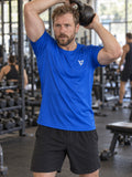 Man training in the Royal Blue Essential men's sports jersey with the Vantacore V emblem on the left chest – front view