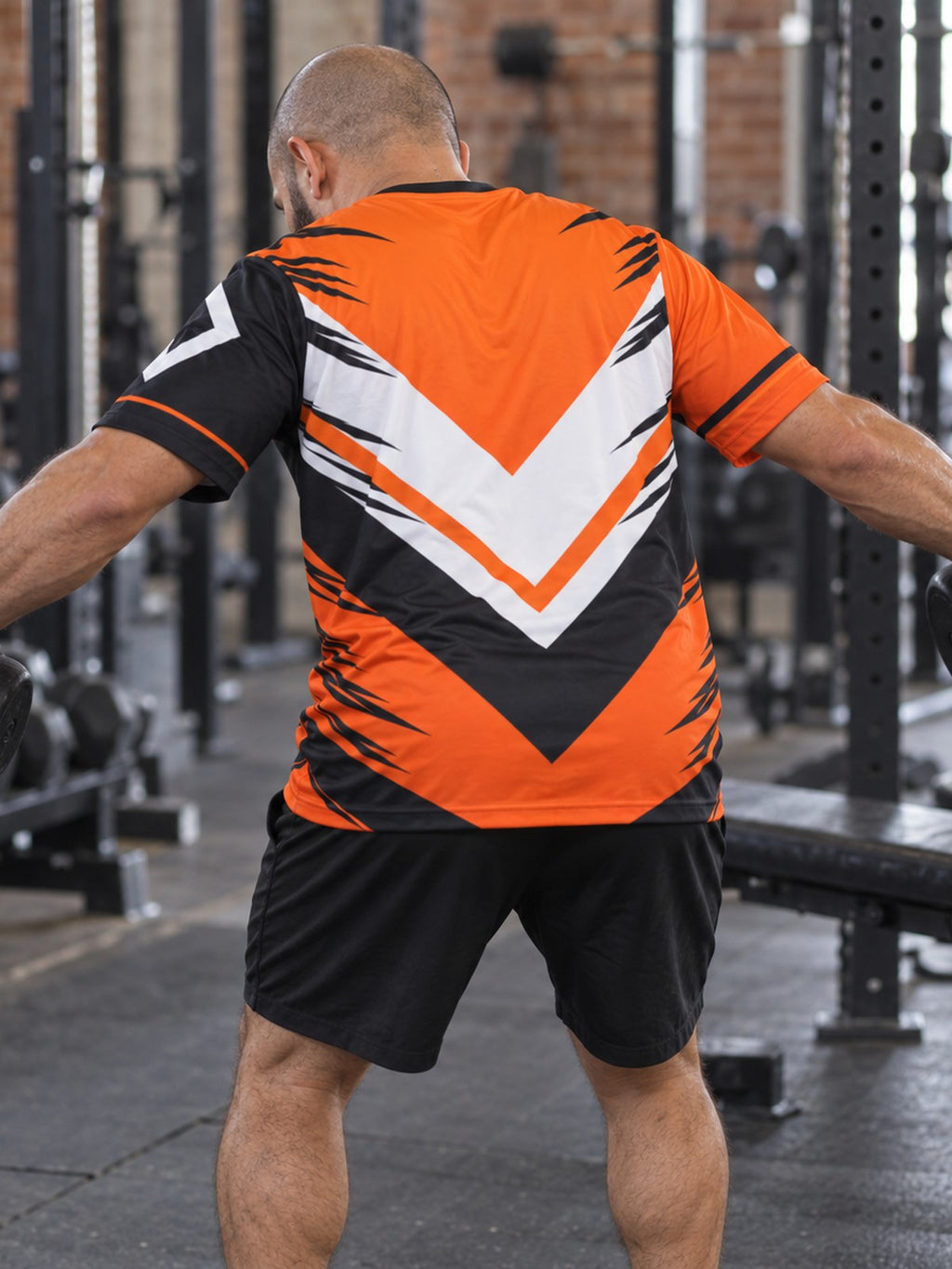Man training in the Inferno Strike men's sports jersey with the Vantacore V emblem on the left chest – back view