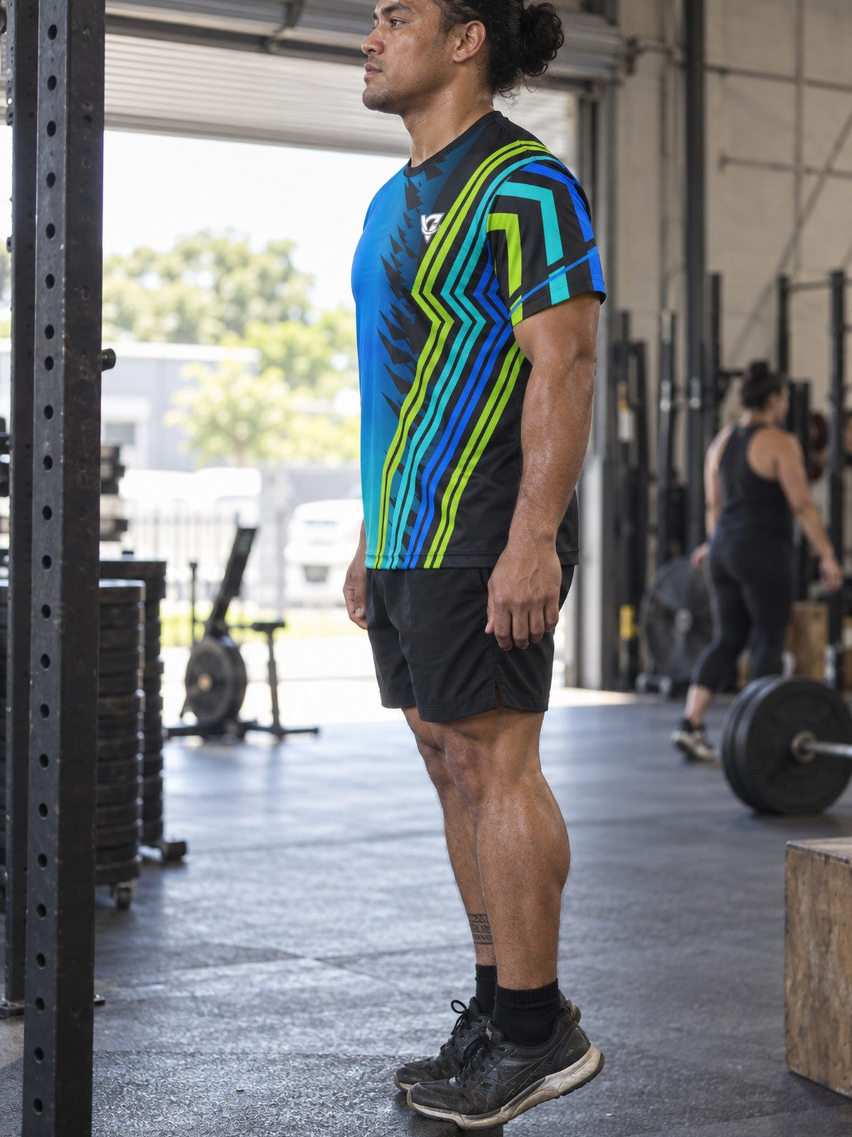 Man training in the Ocean Surge men's sports jersey with the Vantacore V emblem on the left chest – side view