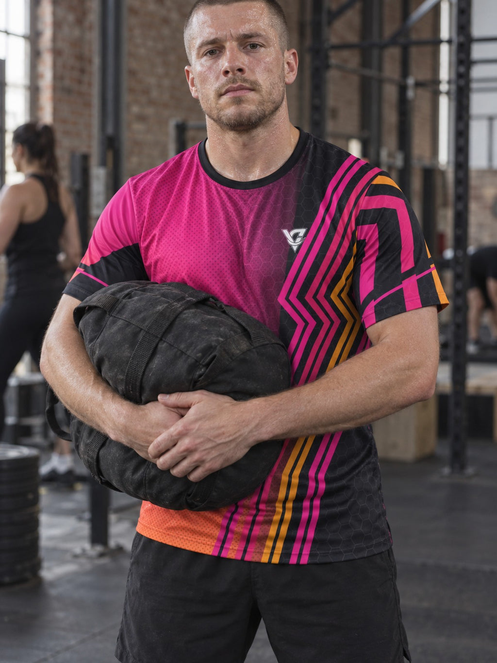 Man training in the Neon Magenta Inferno men's sports jersey with the Vantacore V emblem on the left chest – front view