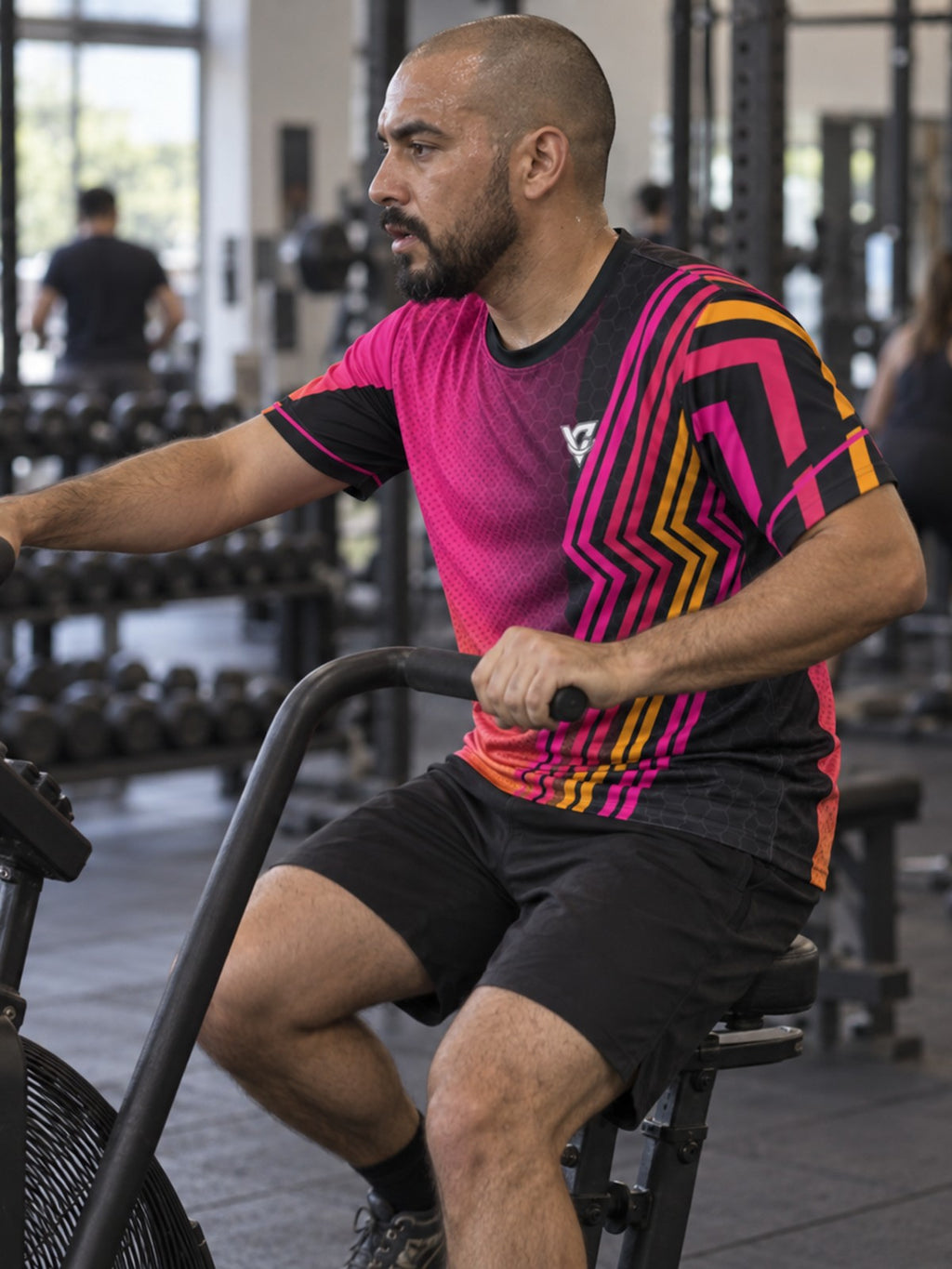 Man training in the Neon Magenta Inferno men's sports jersey with the Vantacore V emblem on the left chest – side view
