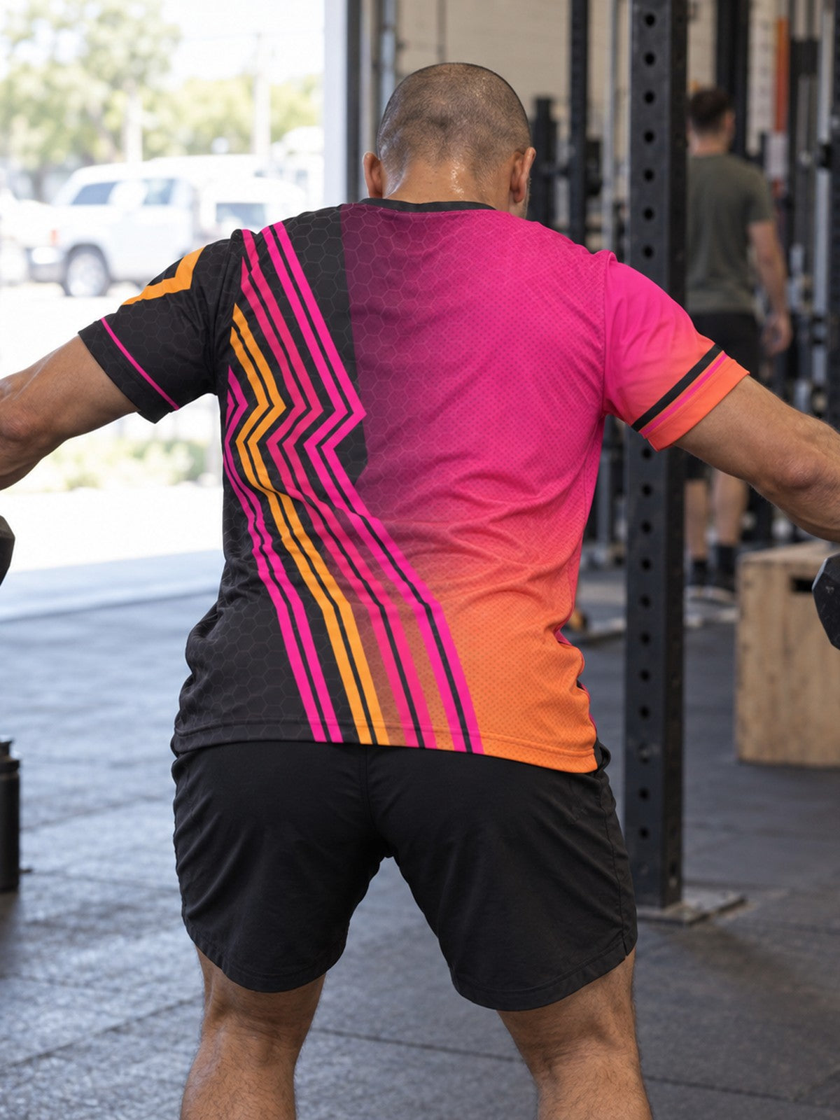 Man training in the Neon Magenta Inferno men's sports jersey with the Vantacore V emblem on the left chest – back view