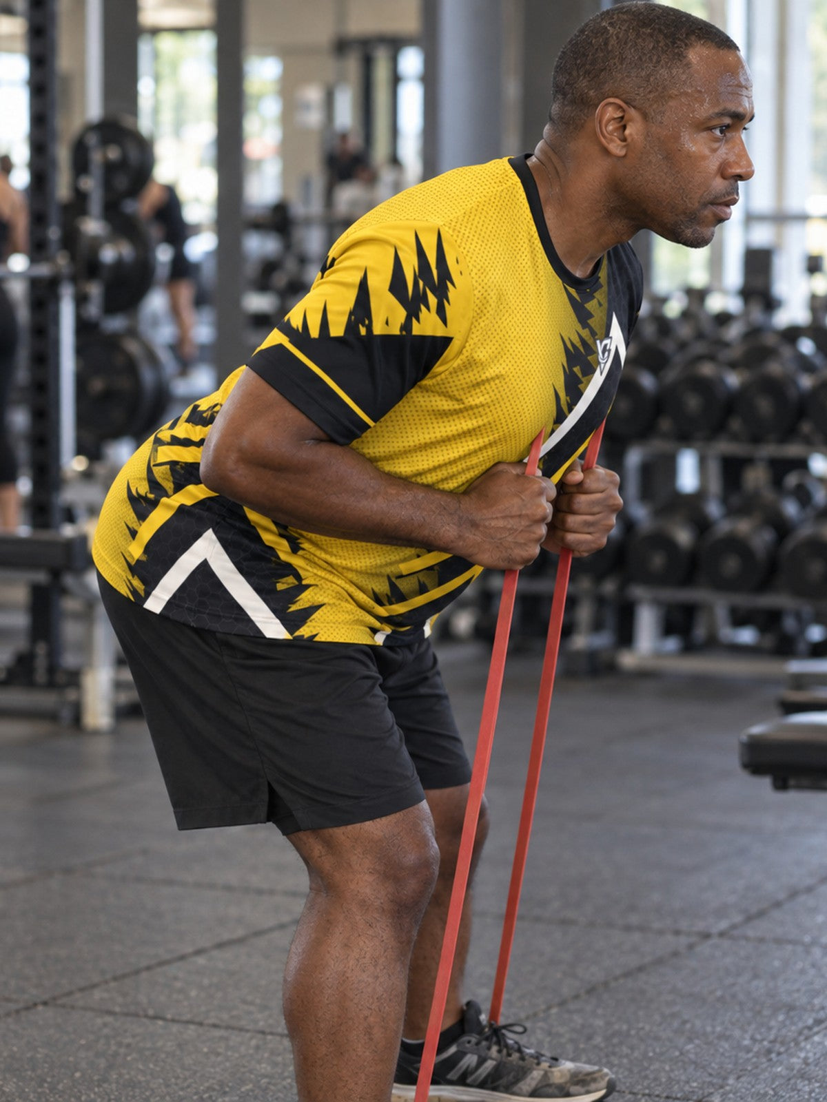 Man training in the Golden Apex men's sports jersey with the Vantacore V emblem on the left chest – side view