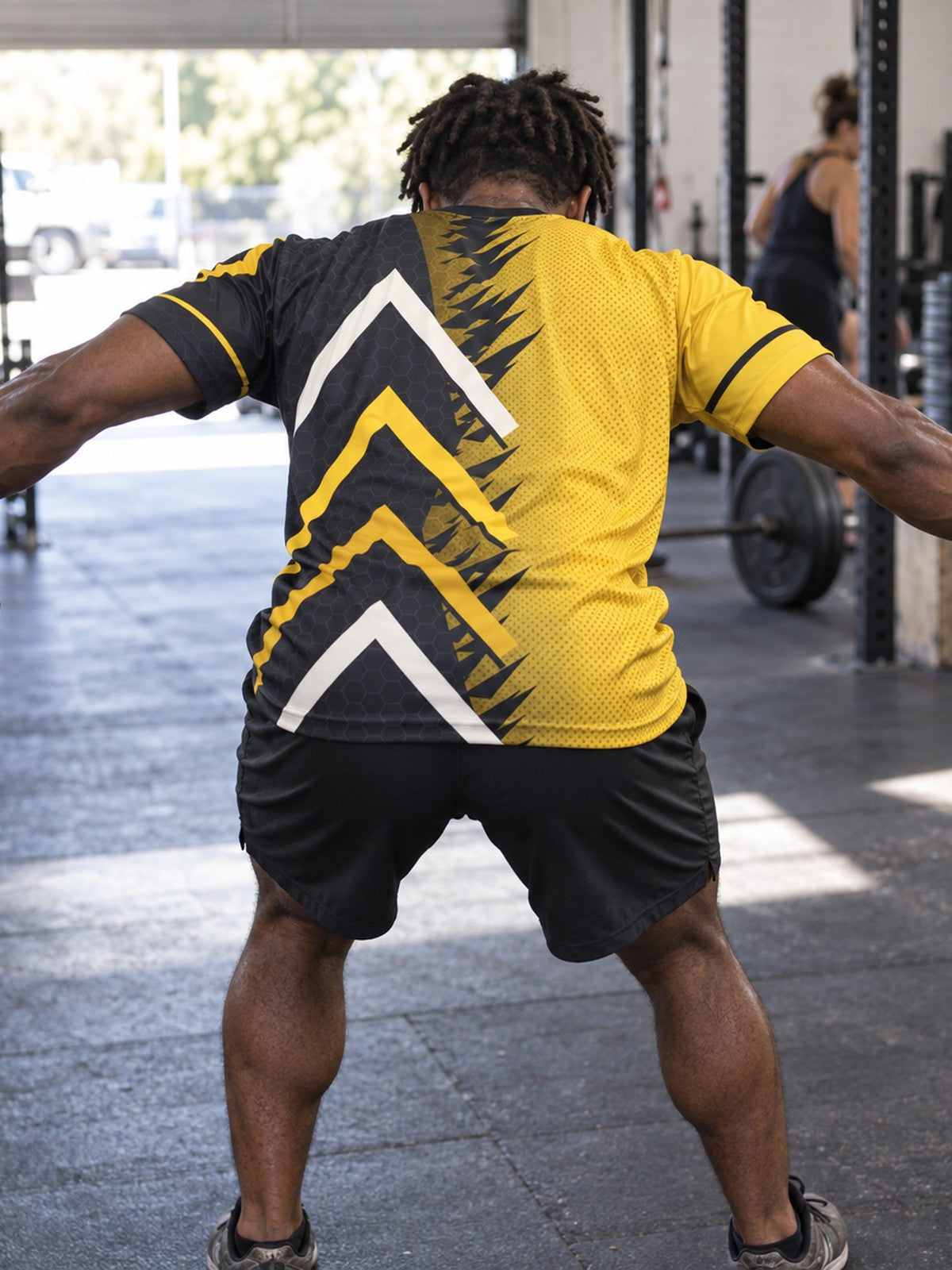 Man training in the Golden Apex men's sports jersey with the Vantacore V emblem on the left chest – back view