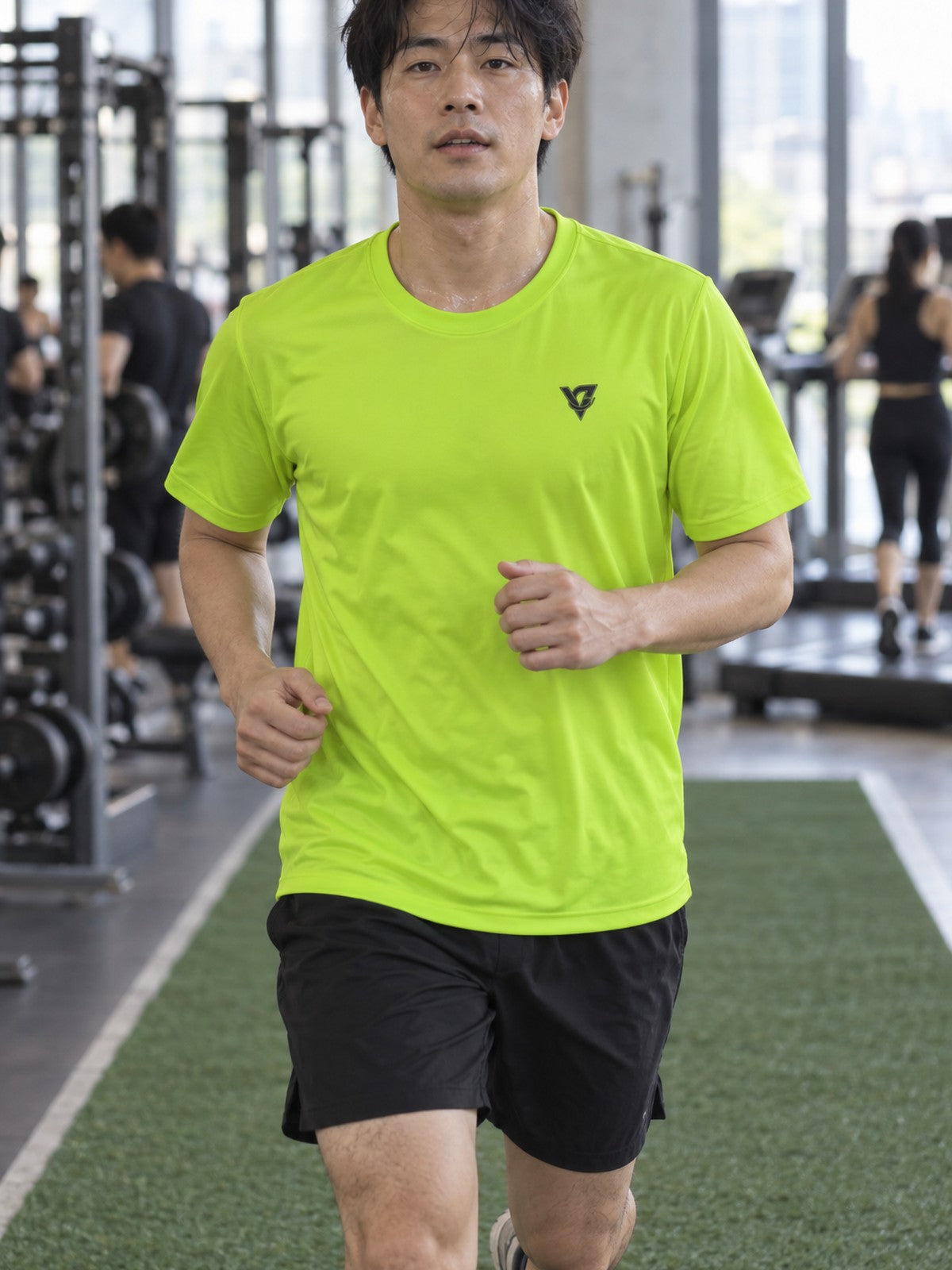 Man training in the Volt Green Essential men's sports jersey with the Vantacore V emblem on the left chest – front view