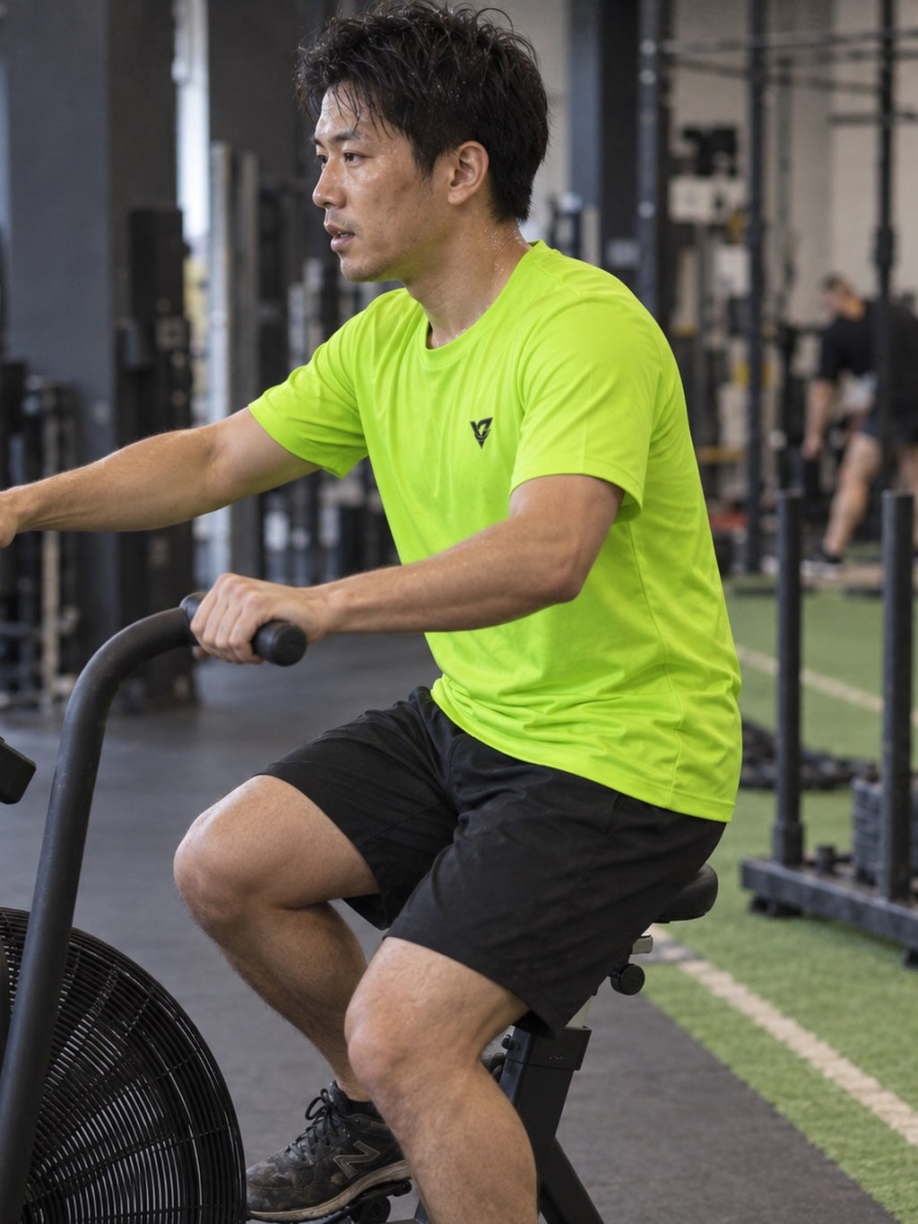 Man training in the Volt Green Essential men's sports jersey with the Vantacore V emblem on the left chest – side view