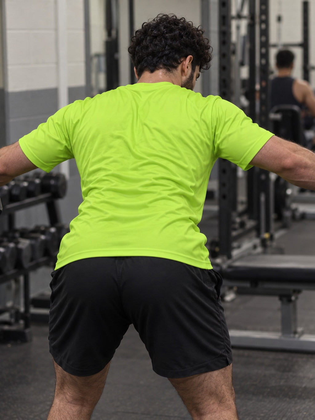 Man training in the Volt Green Essential men's sports jersey with the Vantacore V emblem on the left chest – back view