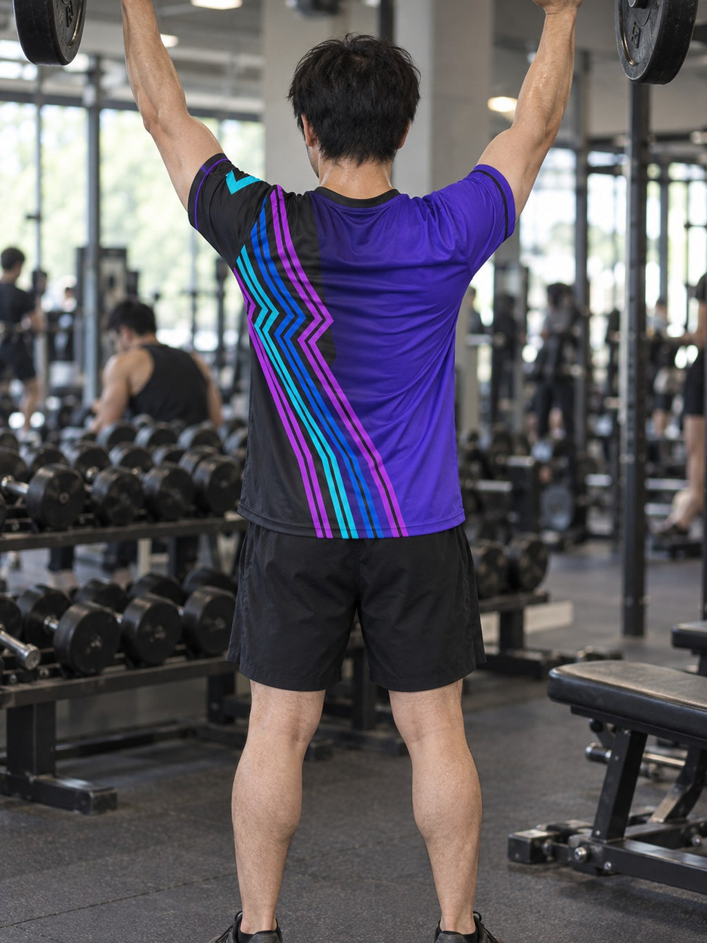 Man training in the Electric Vortex men's sports jersey with the Vantacore V emblem on the left chest – back view
