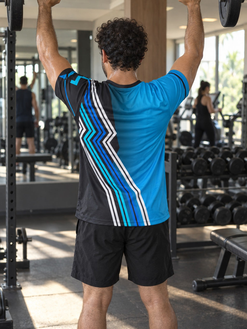 Man training in the Electric Cyan Velocity men's sports jersey with the Vantacore V emblem on the left chest – back view