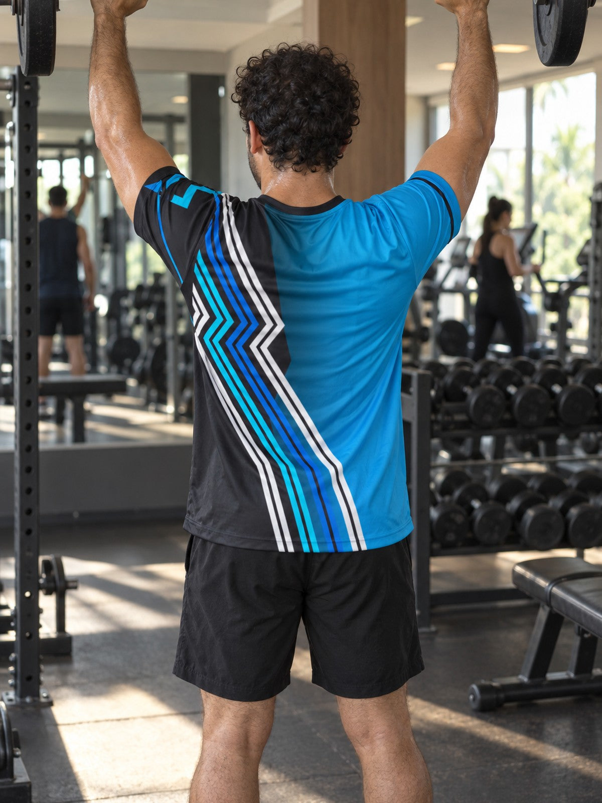 Man training in the Electric Cyan Velocity men's sports jersey with the Vantacore V emblem on the left chest – back view