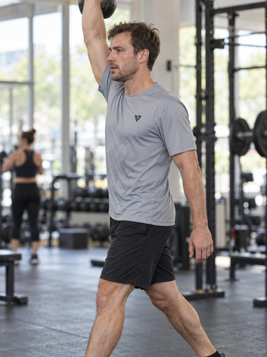 Man training in the Stone Grey Essential men's sports jersey with the Vantacore V emblem on the left chest – side view