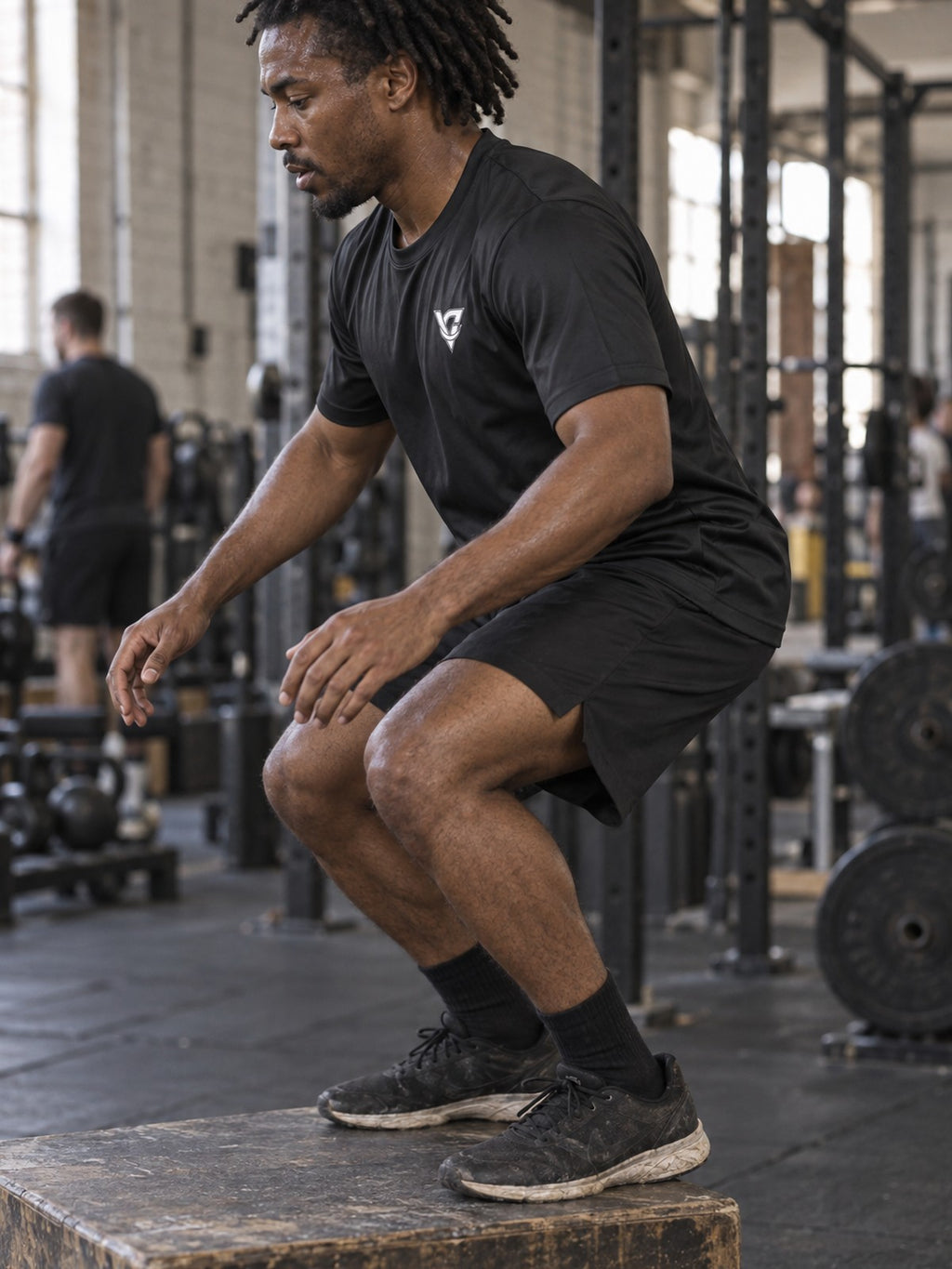 Man training in the Stealth Black Essential men's sports jersey with the Vantacore V emblem on the left chest – side view
