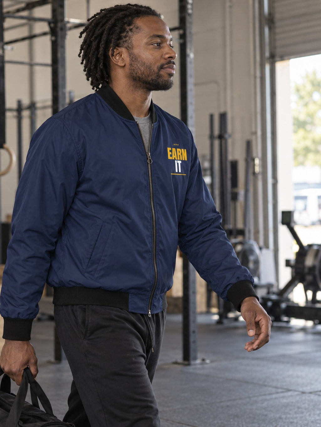 Earn It bomber jacket in navy – side view