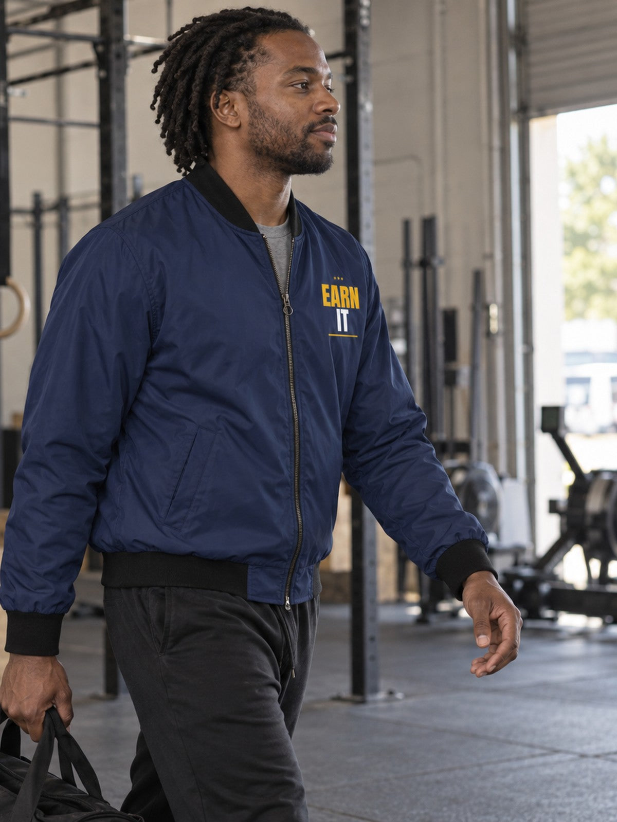 Earn It bomber jacket in navy – side view