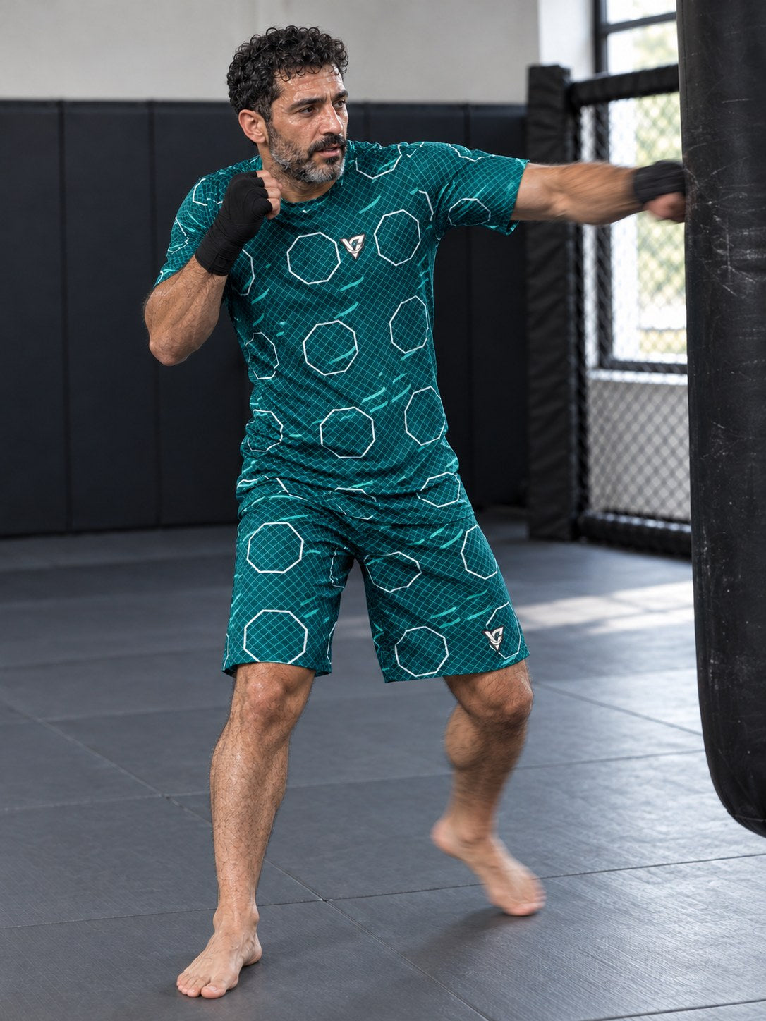 Combat Sports Teal Wave Cage Mesh Men's Athletic Shorts with Pockets, in action