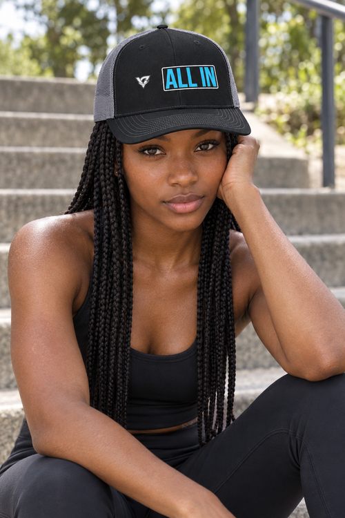 All In structured trucker snapback cap with a mesh back worn on a model