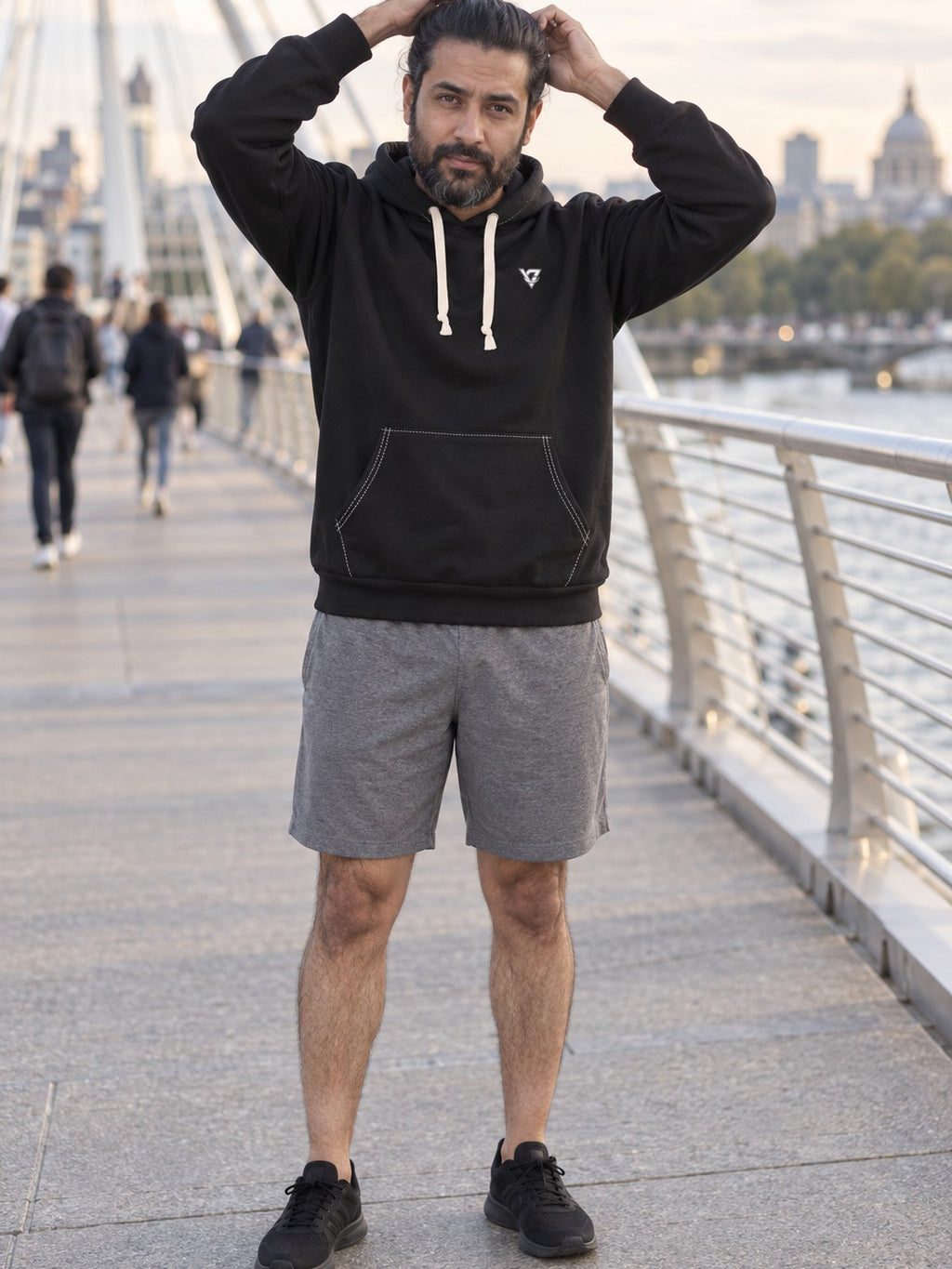 Man wearing the Stealth Black Essential Men's Pullover Hoodie