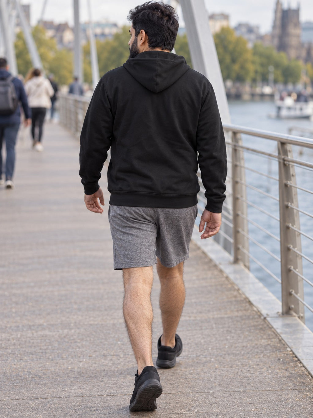 Man wearing the Stealth Black Essential Men's Pullover Hoodie