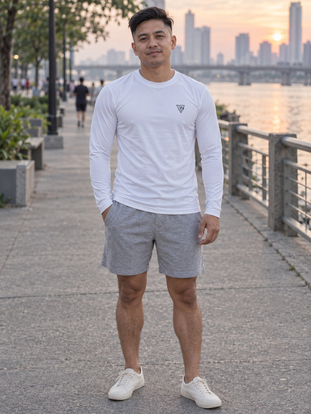 Man wearing the Arctic White Essential Men's Long Sleeve Athletic Shirt