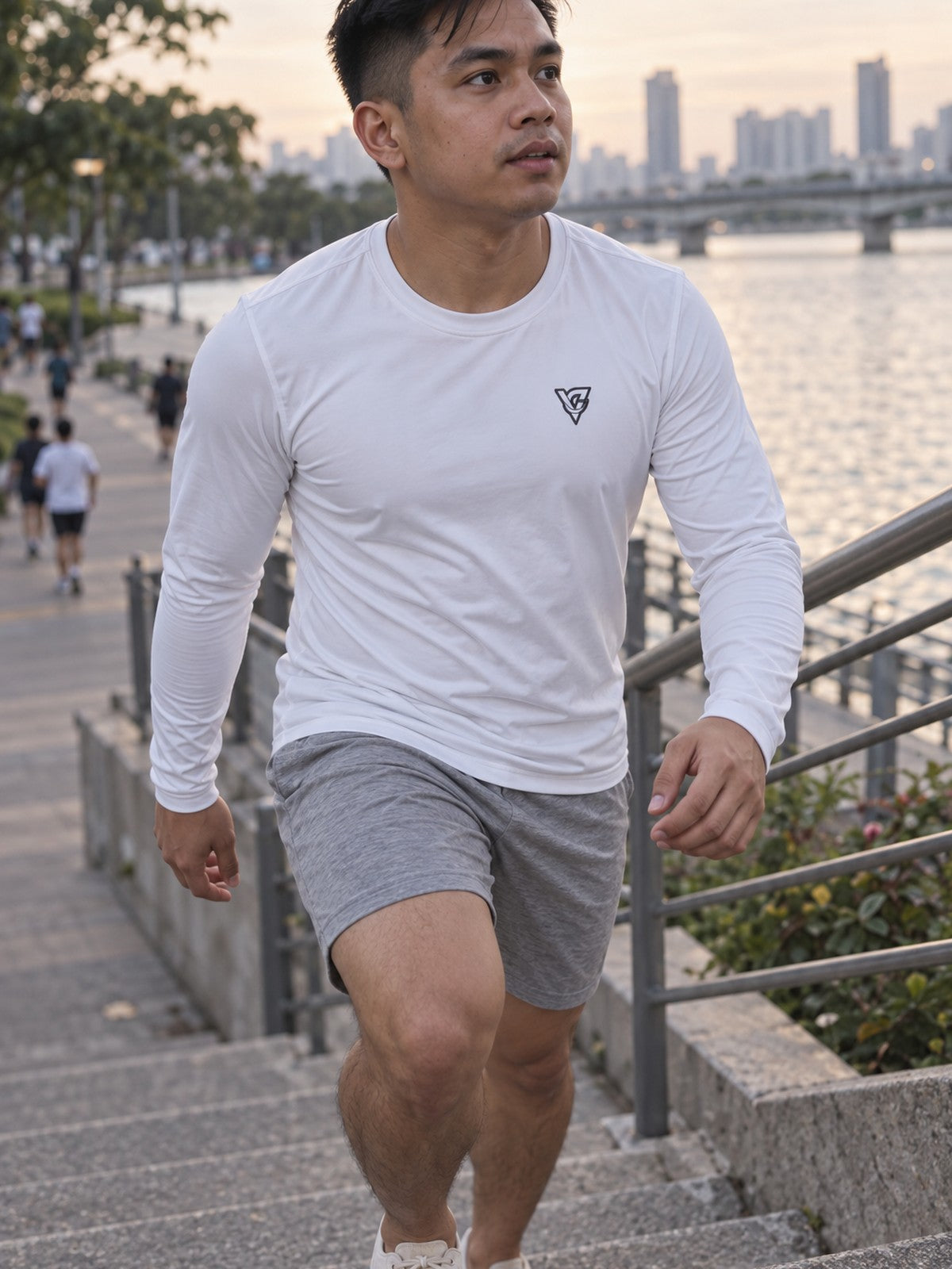Man wearing the Arctic White Essential Men's Long Sleeve Athletic Shirt