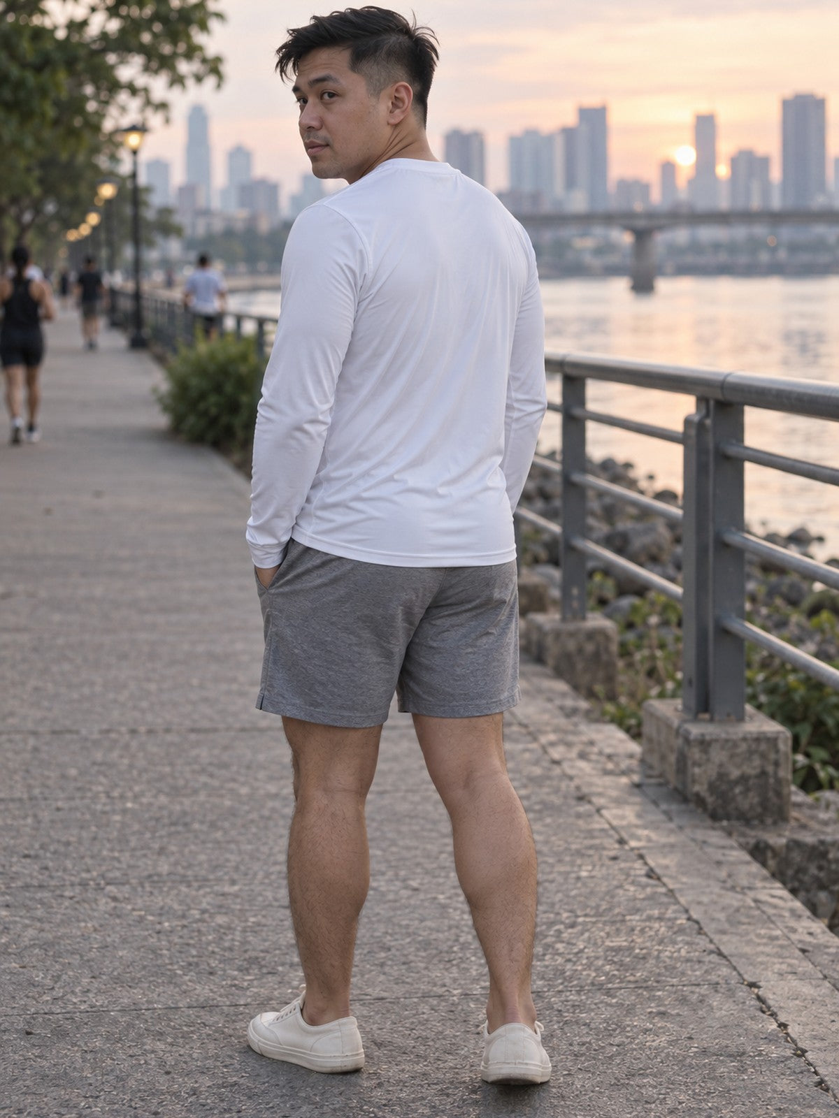 Man wearing the Arctic White Essential Men's Long Sleeve Athletic Shirt